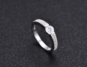 Macro shot of S925 sterling silver ring with large round solitaire and micro-pave diamonds