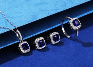 Macro view of sterling silver jewelry set featuring emerald cut blue stones and zircons