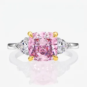 Pink cushion cut stone ring with side triangles in silver and gold-tone setting