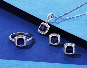 Macro shot of S925 silver jewelry set featuring square-cut dark blue gemstones