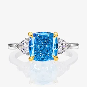 Radiant square blue gemstone ring with triangular side stones on polished silver band