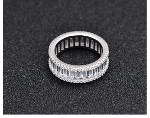 Macro shot of silver S925 eternity ring with rectangular zircons and side accents