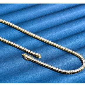 Detailed macro view of 4mm gold tennis necklace with square princess cut zircons