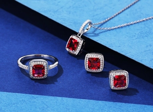Detailed view of S925 silver jewelry set with emerald-cut red gemstones and halo diamonds