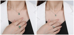 Detailed view of silver necklace and ring set with emerald-cut green gemstones on a model