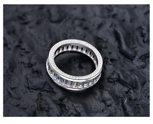 Macro shot of S925 sterling silver ring with 925 stamp and cubic zirconia on black rock