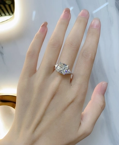 Macro view of 925 sterling silver ring with three-stone sapphire and triangle diamonds