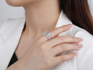 Close-up of a triple layered S925 silver ring with baguette and round cubic zirconia on a model