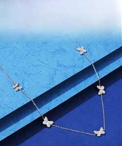 Detail of S925 sterling silver butterfly necklace with 5A zircon inlay on blue steps
