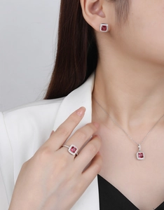 Close-up of S925 sterling silver set featuring square red emerald-cut stones and diamonds