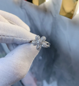 Macro view of 925 silver ring featuring a micro-paved five-petal flower with gems