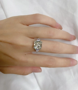 Detailed close-up of a three-stone 925 silver ring featuring a large ice-cut center gem