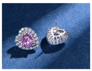 Macro view of heart-shaped pink stud earrings with double halo diamonds and back view details