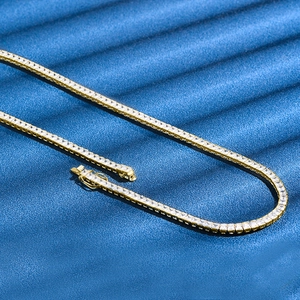 Classic 4mm gold tennis chain featuring continuous square-cut cubic zirconia crystals