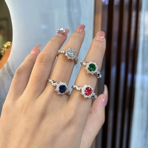 Elegant four-prong silver ring set with round cut colored crystals and twisted band