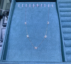 Detailed view of S925 sterling silver butterfly necklace with five sparkling zircon pendants