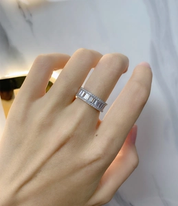 Detail of S925 sterling silver band ring featuring rectangular and round pavé diamonds