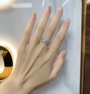 Macro shot of silver baguette-cut cubic zirconia eternity ring worn on finger