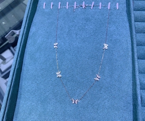 Detailed view of S925 sterling silver necklace featuring five butterfly pendants with zircons