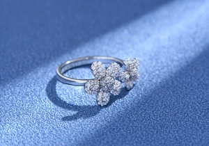 Macro shot of S925 sterling silver daisy ring with micro-pave crystals on navy background