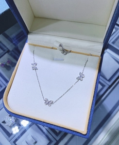 Detail of S925 silver necklace featuring three sparkling butterfly pendants with zircons