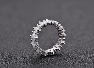 Macro side view of S925 silver eternity ring with trapezoid baguette-cut diamonds