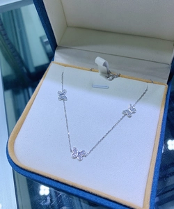 Detailed view of silver butterfly necklace with three zircon butterfly pendants