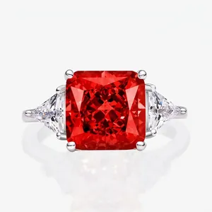 Three-stone ring with square red gemstone and triangle white side stones on silver band