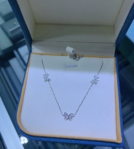 Macro detail of S925 sterling silver butterfly necklace with micro-pave cubic zirconia