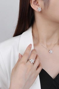 Close-up of s925 silver flower jewelry set with micro-pave zircons on an Asian model