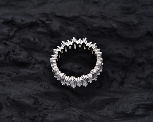 Macro detail of S925 silver ring featuring channel-set baguette-cut cubic zirconia diamonds