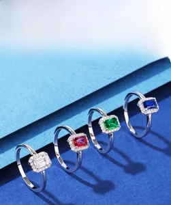 Detail of 925 silver rings set with emerald-cut 5A cubic zirconia in various colors