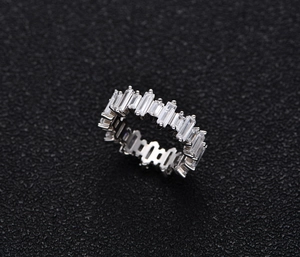 Macro shot of S925 sterling silver ring with baguette-cut stones in a row design