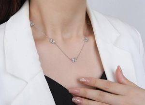 Close-up of S925 sterling silver butterfly necklace with zircons worn on female neck