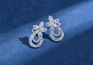 Macro detail of silver floral drop earrings with marquise and pavé cubic zirconia