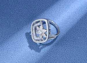 Macro detail of S925 silver flower ring with intricate zircon pavé setting and hollow design