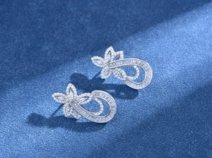 Detailed macro view of S925 silver flower earrings with pavé set white cubic zirconia