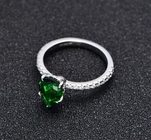 Detailed macro shot of S925 sterling silver hallmark on pear-cut green gemstone ring