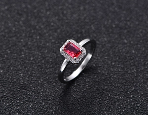 Macro shot of S925 silver ring featuring a rectangular red zircon and pavé halo