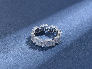 Detailed close-up of a S925 sterling silver eternity ring with trapezoid-cut cubic zirconia