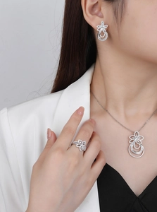 Close-up of model wearing floral S925 silver jewelry set with sparkling pavé zircons
