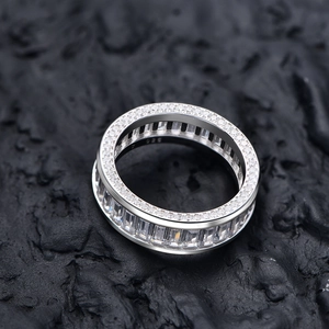 S925 sterling silver eternity ring with rectangular zircons on dark rock surface