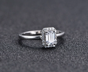 Detailed close-up of emerald-cut cubic zirconia ring with refined halo setting on S925 silver