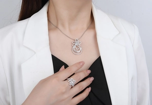 Detail view of silver S925 flower necklace and ring set with pavé cubic zirconia