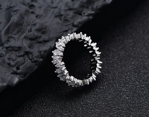 Macro view of S925 sterling silver ring featuring baguette cut cubic zirconia stones