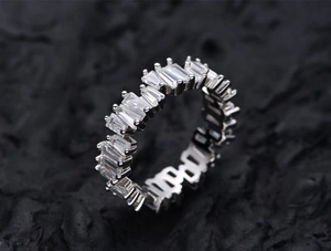 Macro shot of S925 sterling silver eternity ring featuring staggered baguette-cut stones