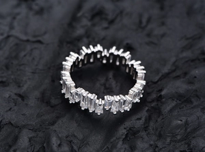 Macro shot of staggered trapezoid baguette zircon stones set in an S925 silver ring band