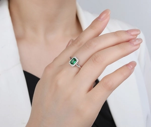 Macro detail of S925 silver ring featuring a rectangular emerald-cut green zircon stone