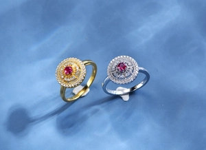 Macro shot of 925 silver rings with round ruby center and hollow pavé diamond halo