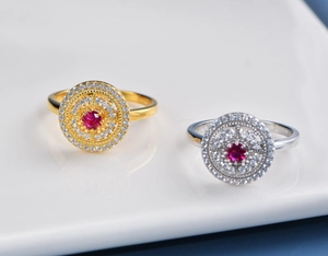 Macro detail of gold and silver hollow rings with red rubies and multi-layer diamonds
